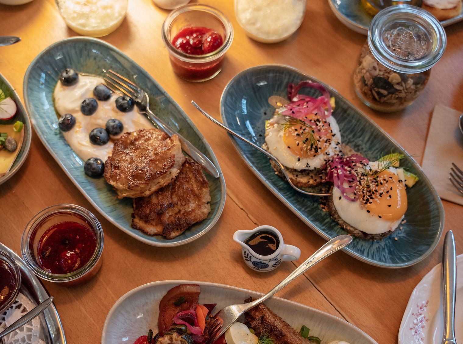 Frühstückstisch mit Pancakes, Spiegeleiern, Brot, Marmelade und weiteren Gerichten im Lund Sylt.